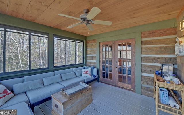 sunroom with ceiling fan and wood ceiling