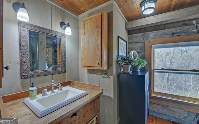 bathroom with vanity, wooden ceiling, and plenty of natural light