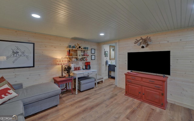 living room with light hardwood / wood-style flooring and wooden ceiling