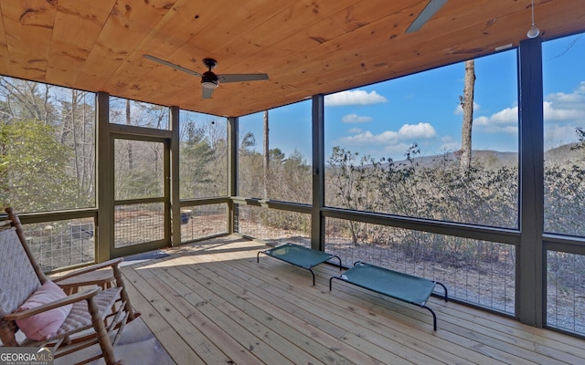 unfurnished sunroom with ceiling fan and wood ceiling