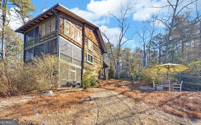 view of property exterior with a sunroom