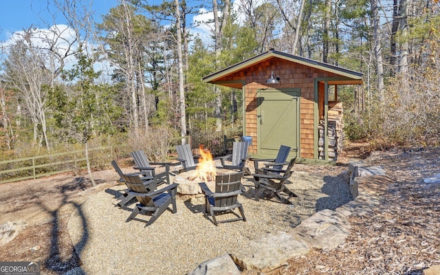 view of patio / terrace featuring a storage unit and a fire pit