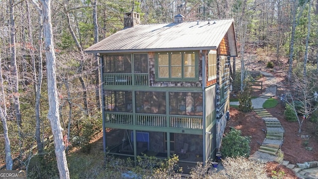 view of outbuilding with a sunroom