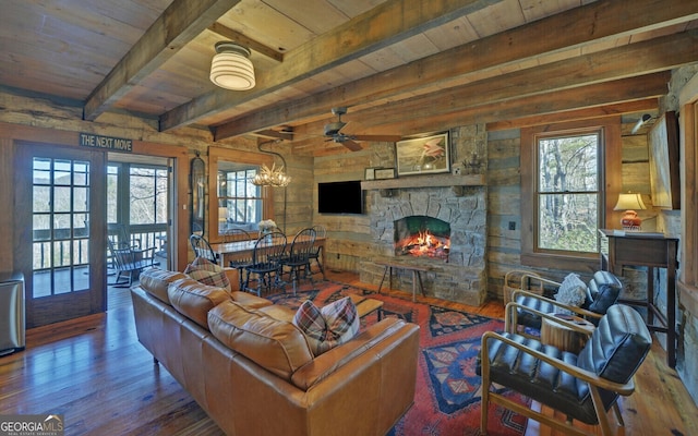 living room featuring beam ceiling, wood-type flooring, wooden ceiling, and a fireplace