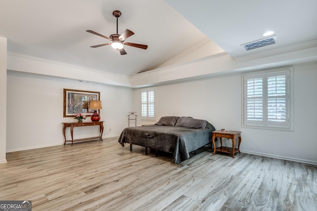 bedroom with ornamental molding, vaulted ceiling, ceiling fan, and light hardwood / wood-style flooring