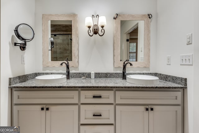 bathroom with tiled shower and vanity