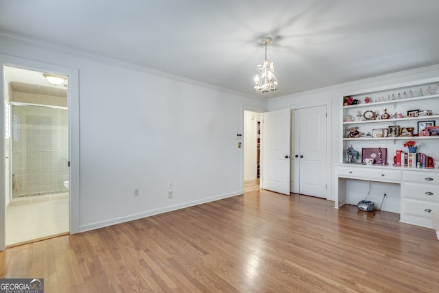 unfurnished bedroom with light wood-type flooring, an inviting chandelier, and crown molding