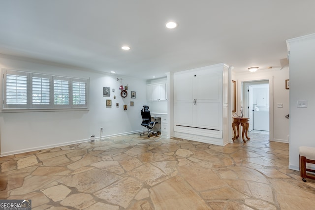 interior space featuring ornamental molding and built in desk