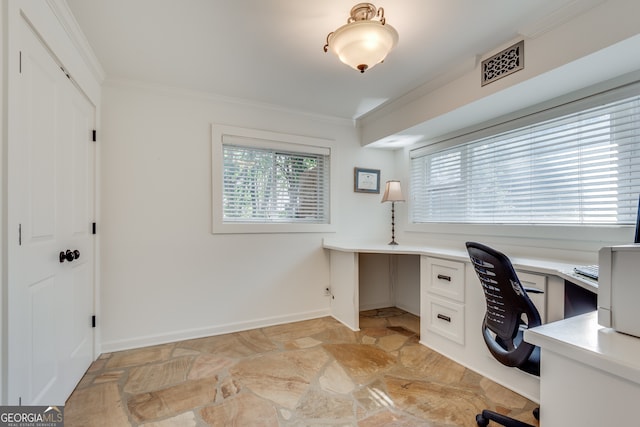 home office with built in desk and crown molding