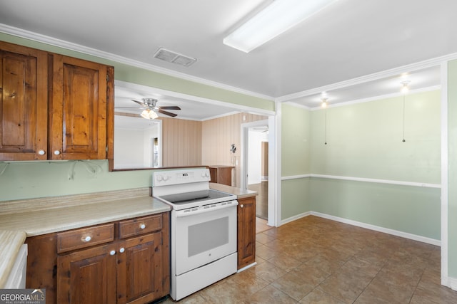 kitchen with electric range, visible vents, light countertops, brown cabinetry, and crown molding