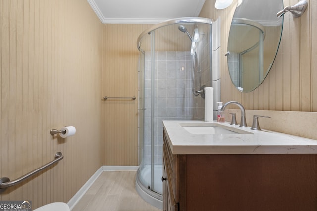 bathroom with a stall shower, crown molding, and vanity