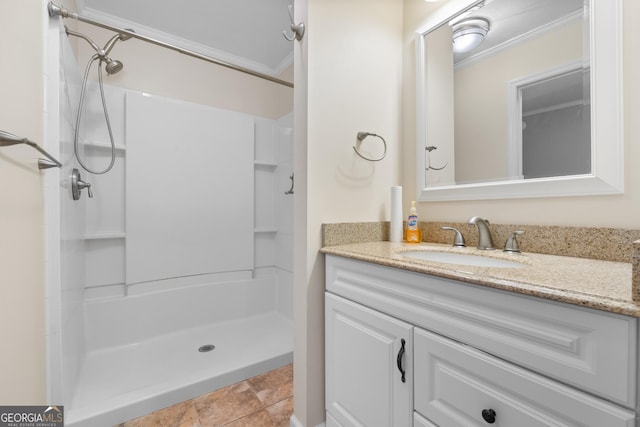 full bathroom featuring ornamental molding, a shower stall, vanity, and tile patterned floors