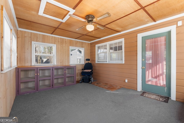 interior space with carpet floors, wood walls, and wood ceiling