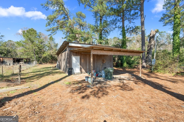 view of outdoor structure with an outbuilding and a carport