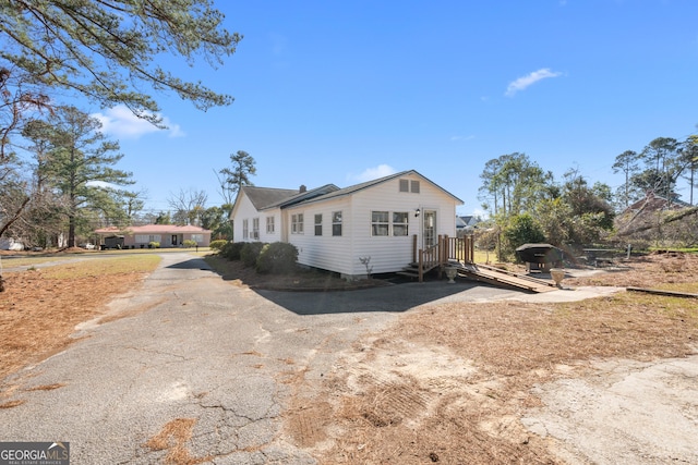 view of property exterior with aphalt driveway