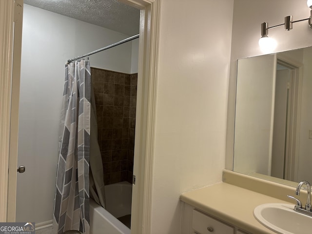 full bath with shower / tub combo, a textured ceiling, and vanity