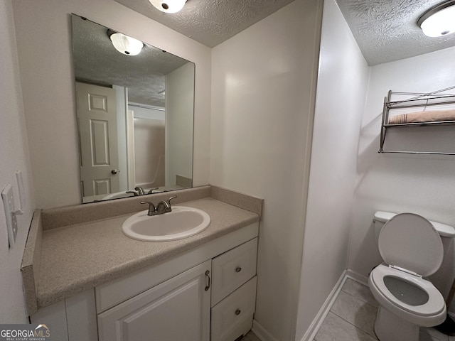 bathroom featuring a textured ceiling, toilet, vanity, baseboards, and tile patterned floors