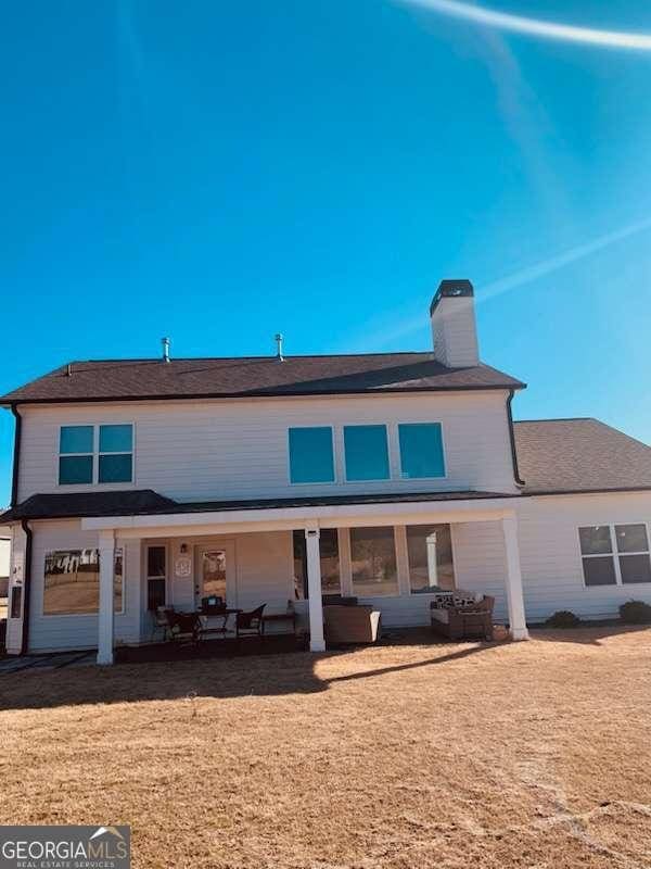 rear view of house with an outdoor hangout area and a patio area