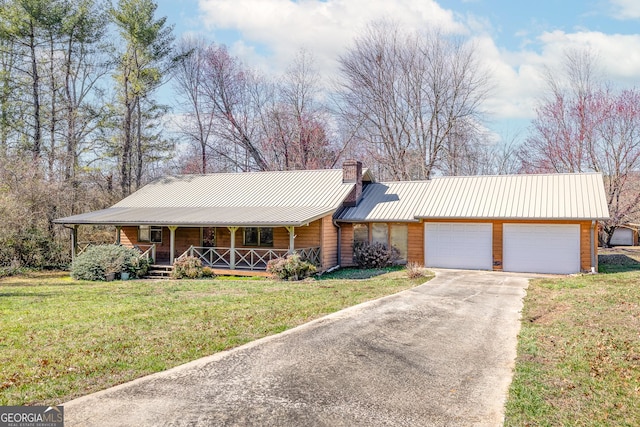 ranch-style house with covered porch, a garage, and a front lawn