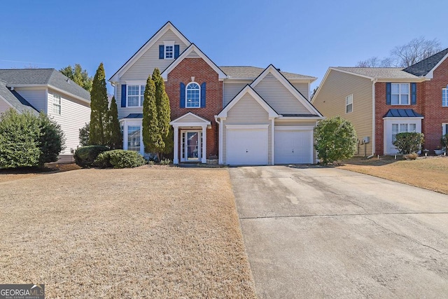 traditional home with a garage, concrete driveway, and brick siding