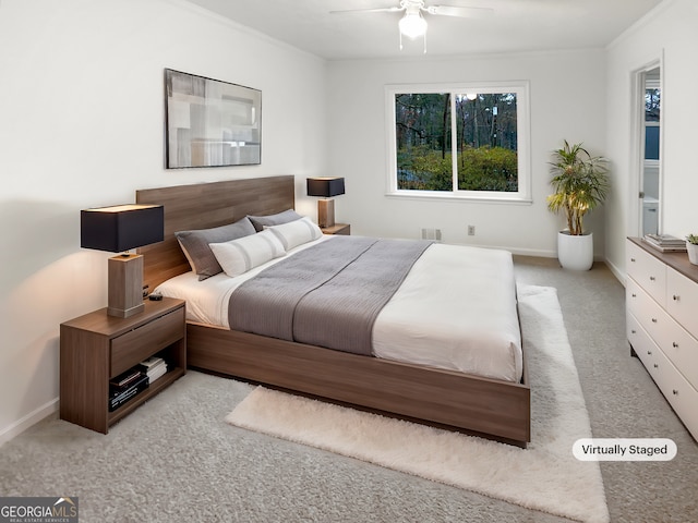 bedroom with ceiling fan and light colored carpet