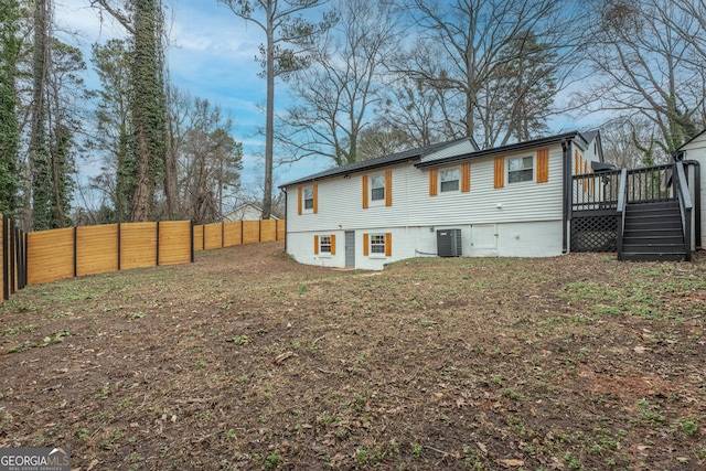 back of property featuring central AC and a wooden deck