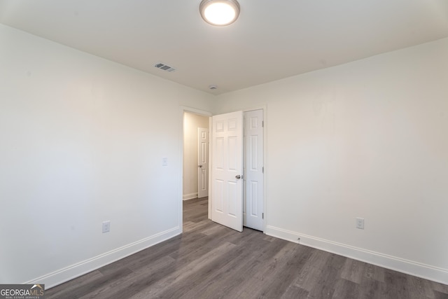 empty room featuring dark hardwood / wood-style flooring