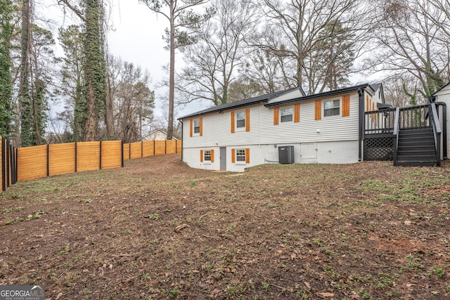 rear view of property with central air condition unit and a deck