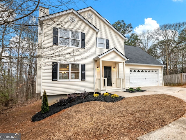 traditional home featuring a garage, roof with shingles, driveway, and a chimney