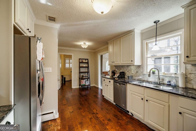 kitchen featuring a baseboard radiator, stainless steel appliances, pendant lighting, ornamental molding, and sink