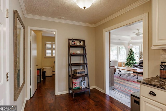 hall featuring a textured ceiling, crown molding, and dark hardwood / wood-style floors