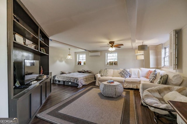 bedroom with dark hardwood / wood-style flooring, ceiling fan, and a wall mounted AC