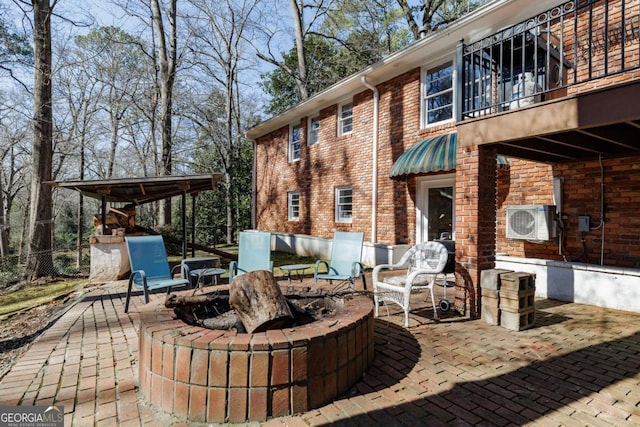 view of patio with an outdoor fire pit and ac unit