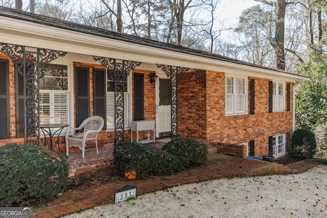 view of exterior entry featuring a patio