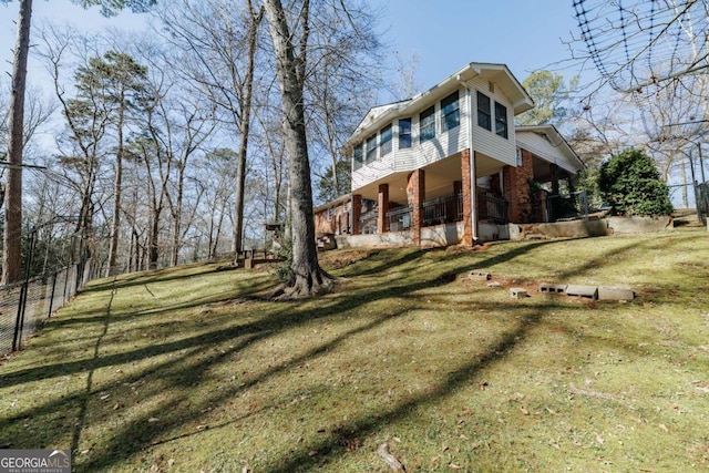 view of side of property with a yard