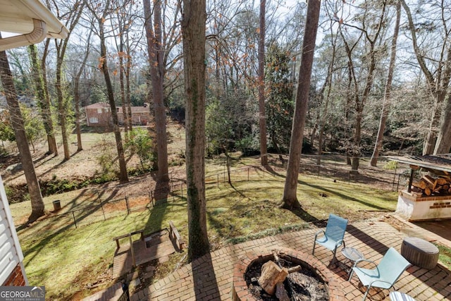 view of yard featuring a patio and a fire pit