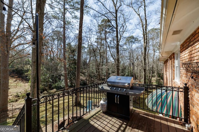 wooden deck featuring grilling area