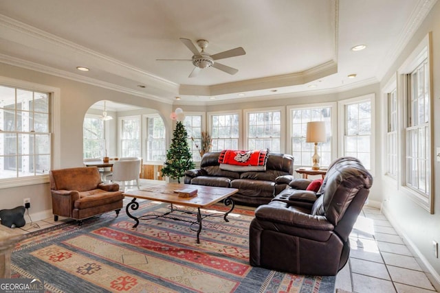 sunroom featuring ceiling fan and a raised ceiling