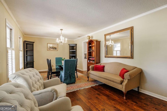 living room featuring ornamental molding, a chandelier, dark hardwood / wood-style floors, and a textured ceiling