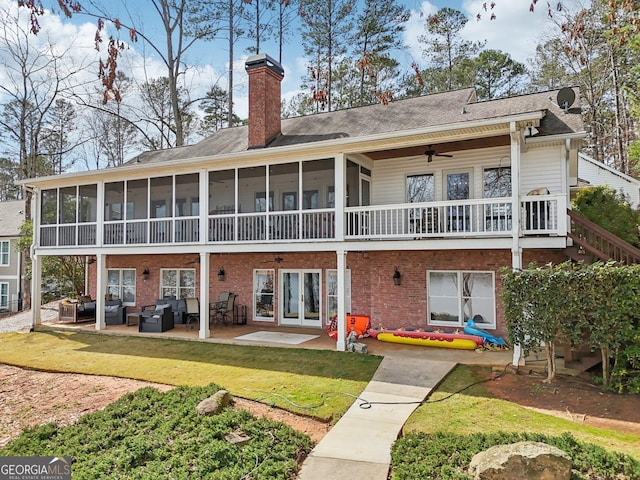 back of house with a lawn, ceiling fan, a patio area, an outdoor hangout area, and a sunroom