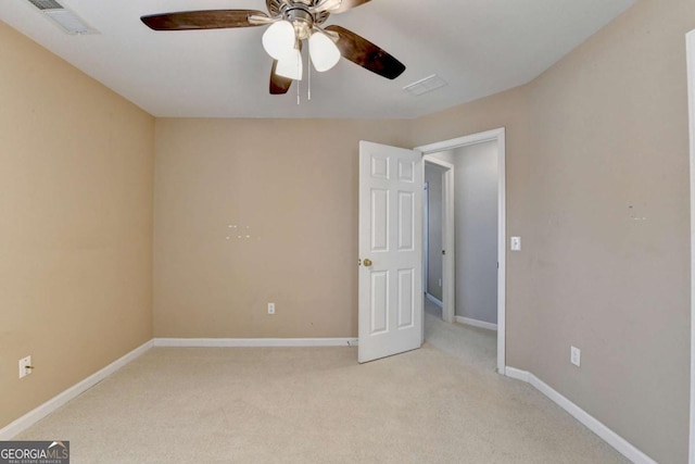 unfurnished bedroom with light carpet and ceiling fan