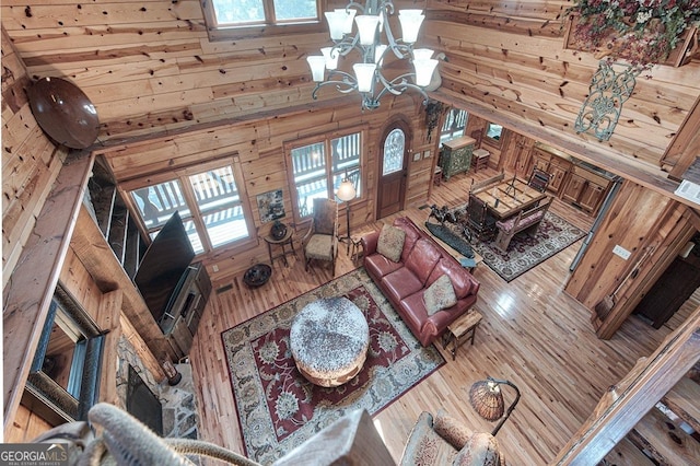 20 Walker Ridge Way Unit 36, 42, Mineral Bluff, GA 30559 - living area with wooden walls, a chandelier, a towering ceiling, and wood finished floors