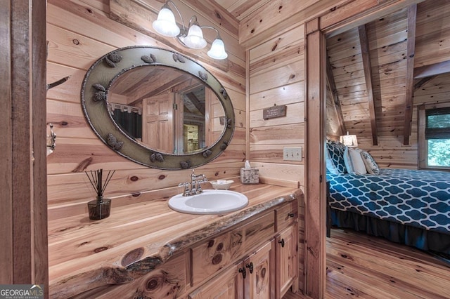 20 Walker Ridge Way Unit 36, 42, Mineral Bluff, GA 30559 - bedroom featuring wood walls, light wood-type flooring, beam ceiling, wooden ceiling, and connected bathroom
