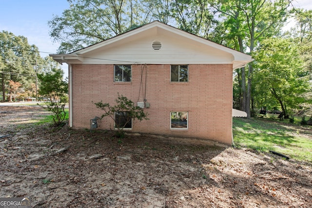 view of side of property featuring brick siding