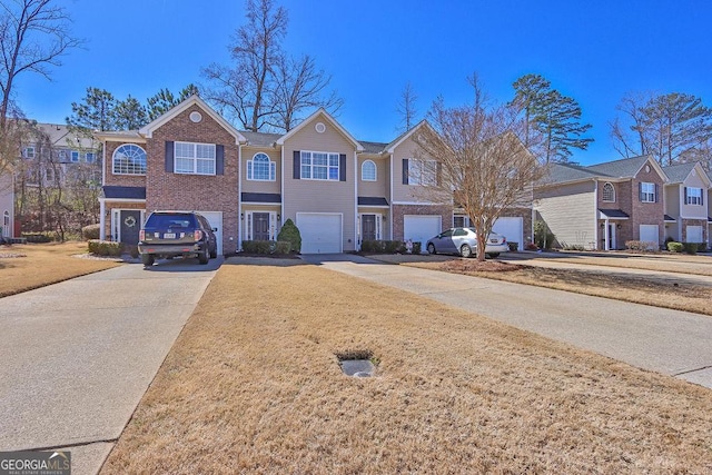 view of front of home featuring brick siding, a residential view, driveway, and a garage