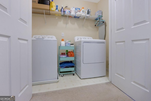 clothes washing area with tile patterned floors, laundry area, and separate washer and dryer