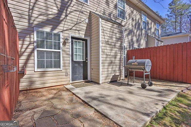 entrance to property with a patio and fence