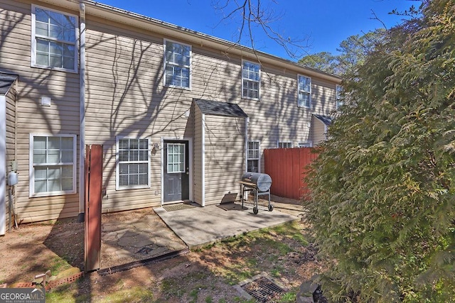 rear view of house featuring a patio area and fence