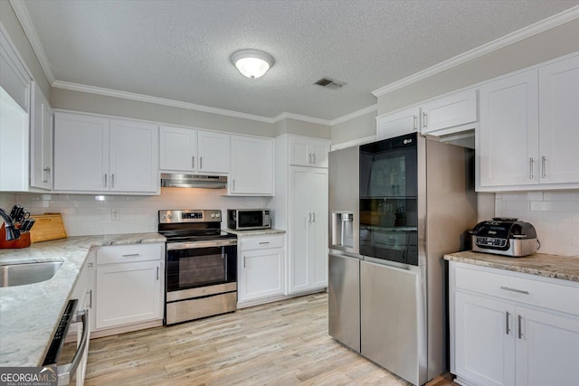 kitchen with white cabinetry, light stone countertops, light hardwood / wood-style floors, sink, and appliances with stainless steel finishes