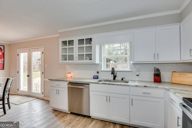 kitchen featuring white cabinetry, stainless steel appliances, light stone counters, and sink